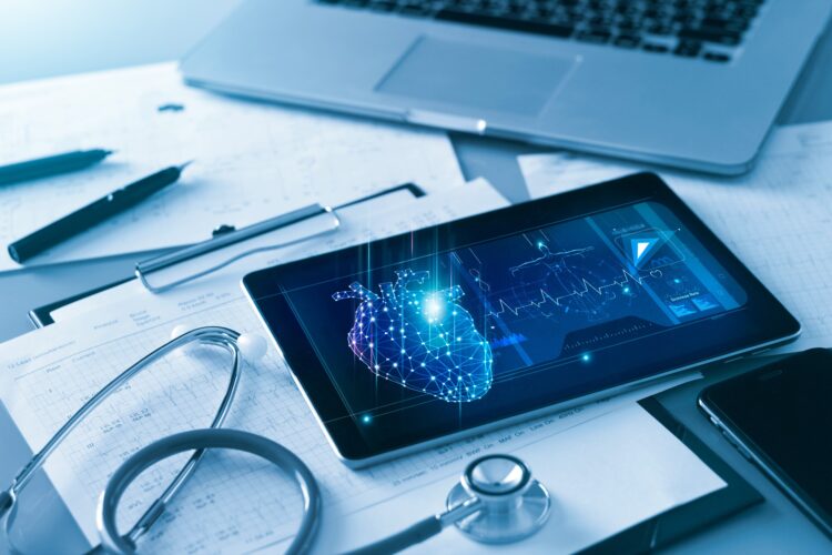 Doctor's cardiologist tablet and heart disease health care analysis data on screen and stethoscope with report heartbeat on table